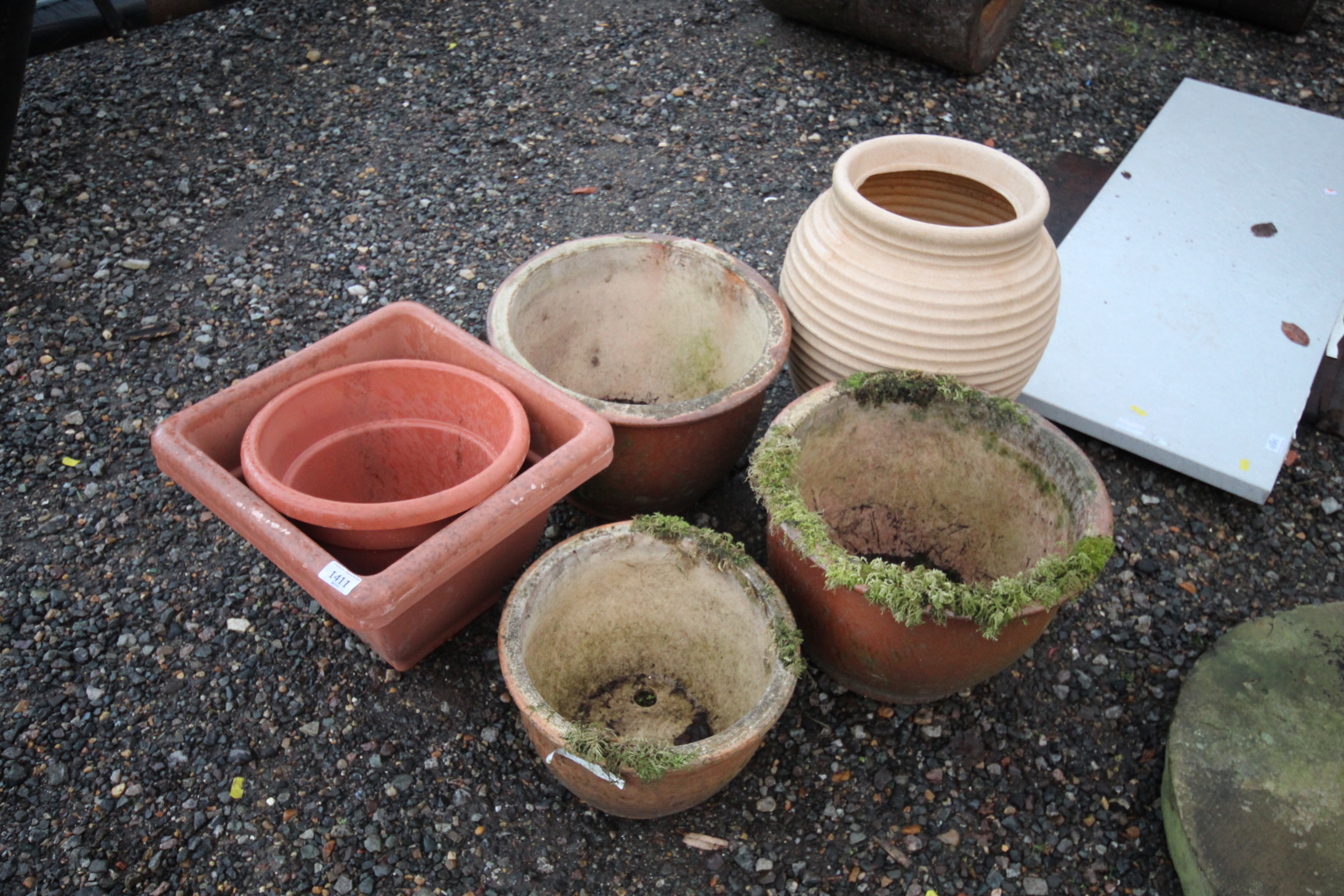 A pair of garden planters; another smaller similar