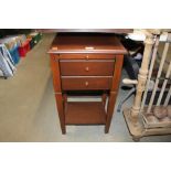 A bedside table fitted two drawers and brushing sl