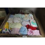A box of various dolls clothes