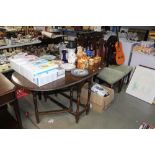 An oak gate legged table and four Edwardian chairs