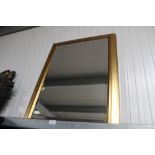 A framed bevelled edge wall mirror