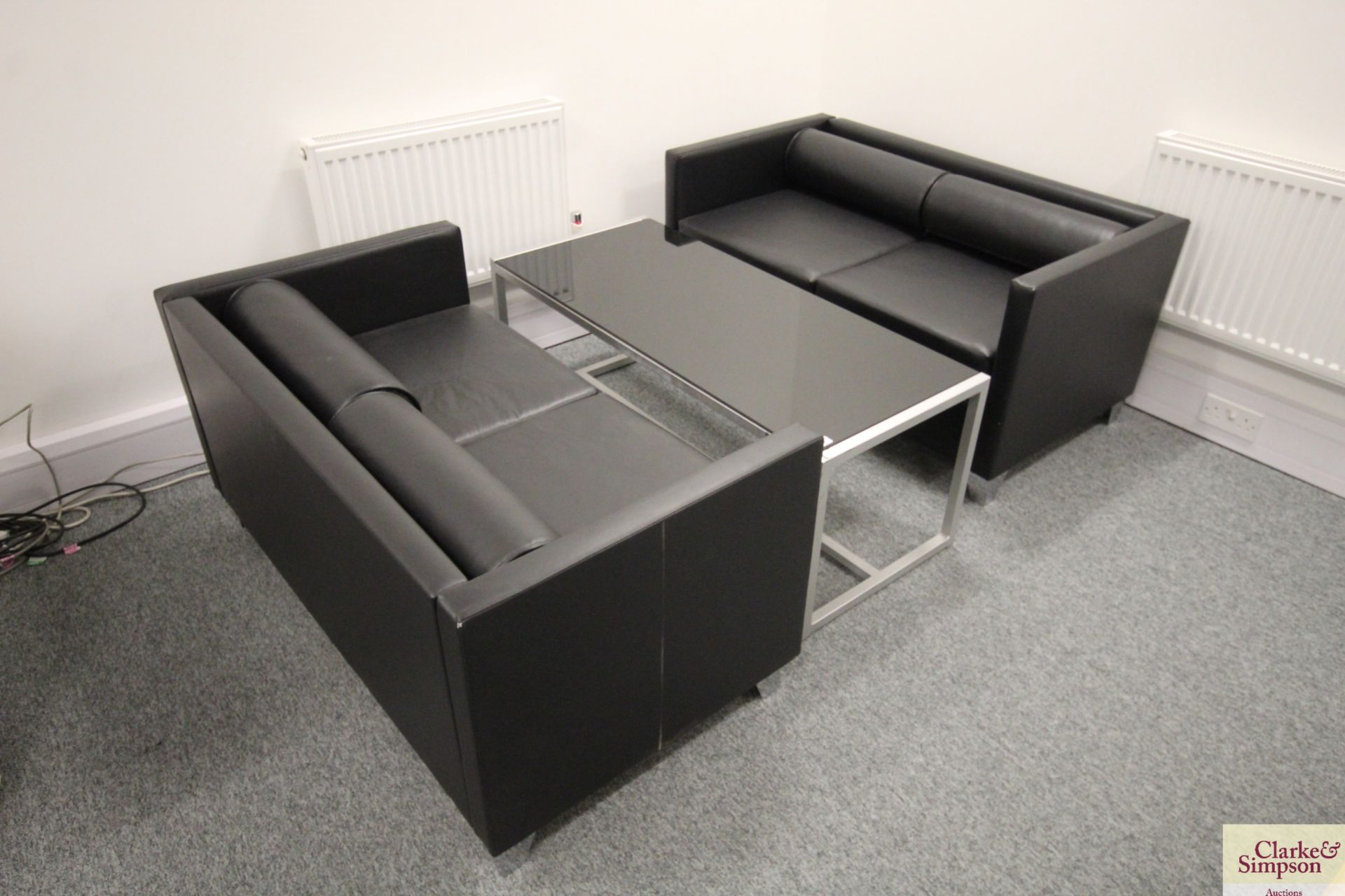 2x two seater leatherette settees with black glass topped coffee table. V