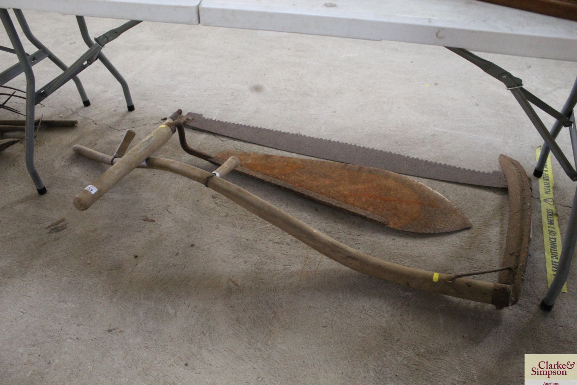 A scythe, a large hay knife and a cross cut saw