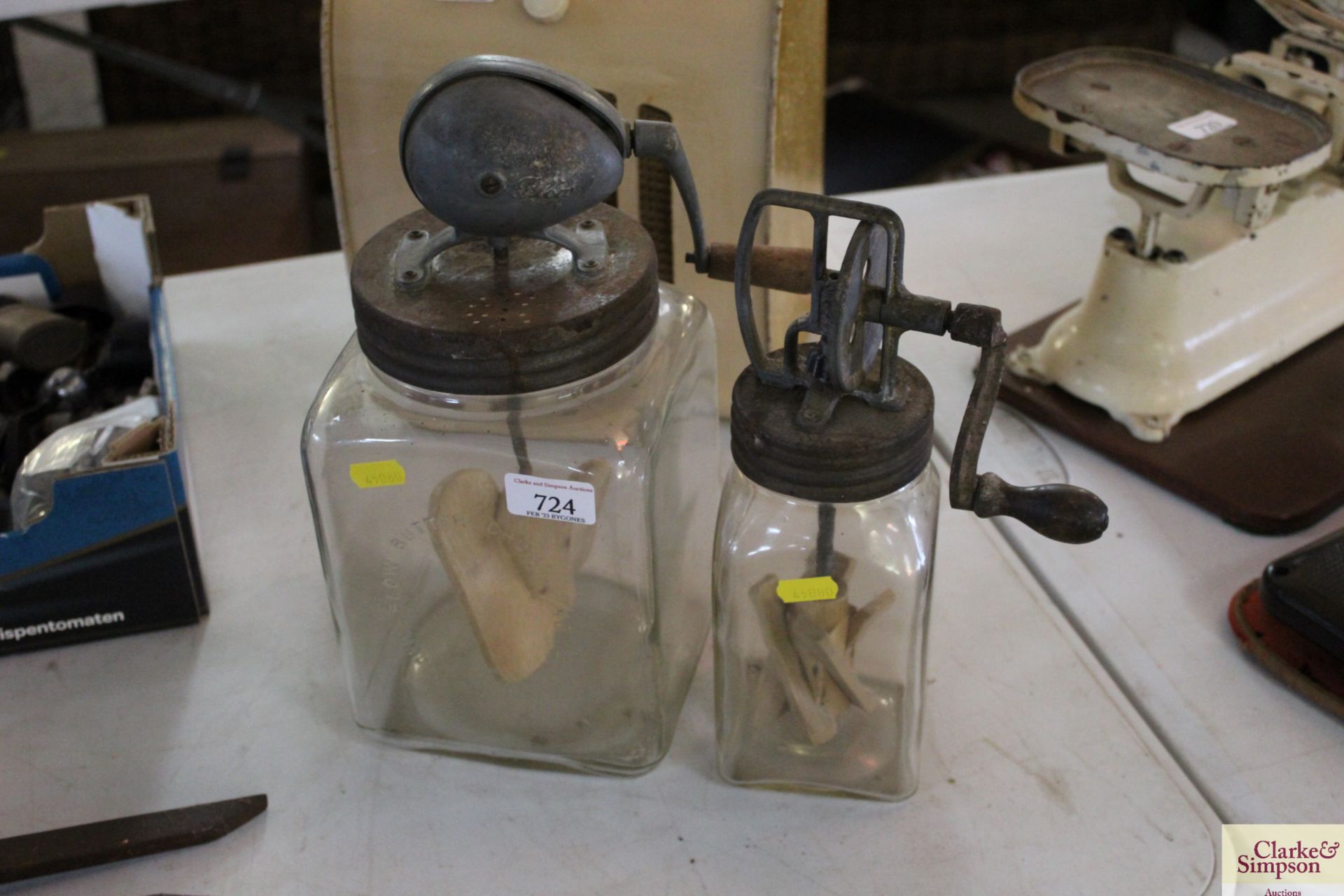 A glass Blow butter churn and a smaller similar