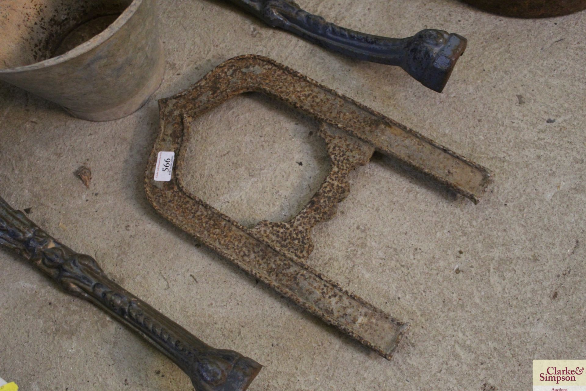 An ornate vintage cast iron boot scraper for door entrance