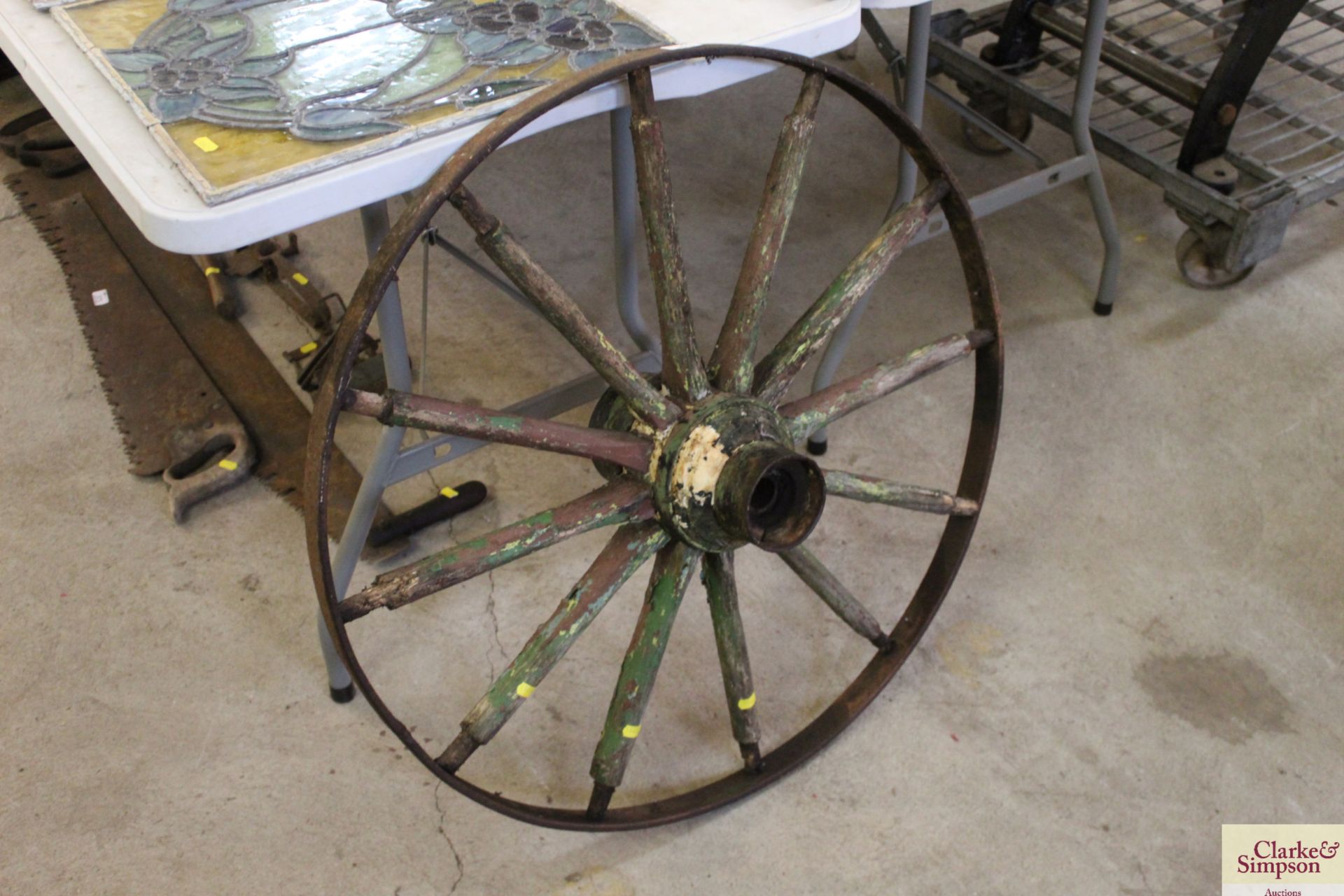 A vintage metal and wooden cartwheel