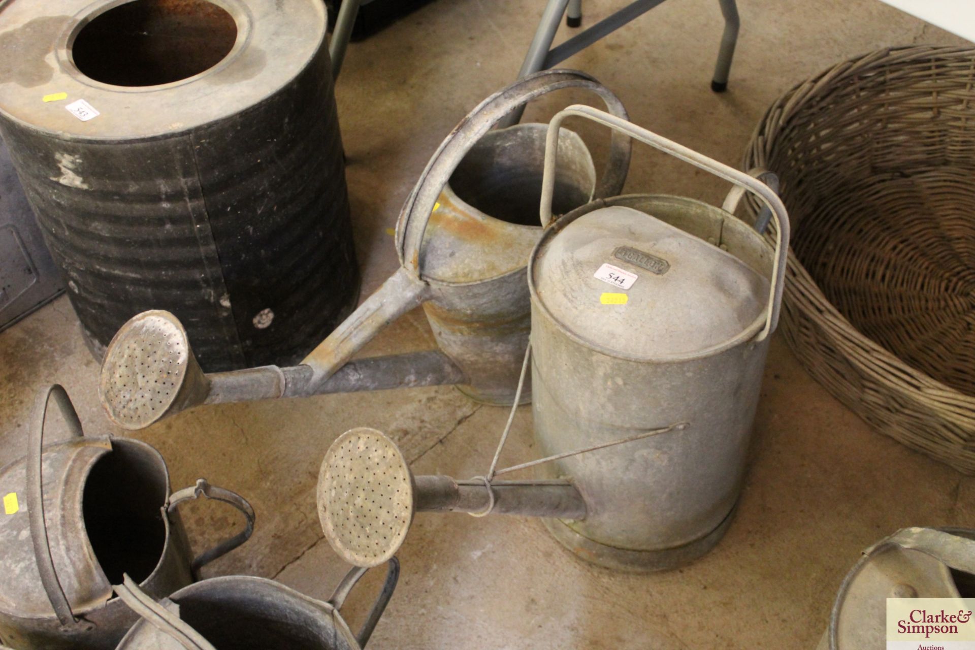 Two large galvanised cans with roses