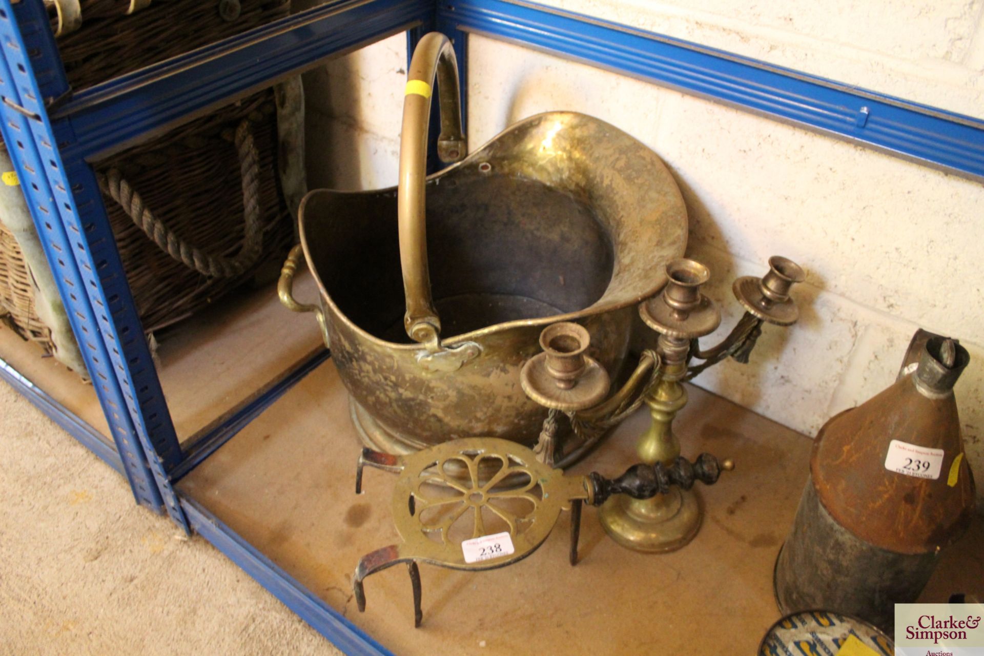 A brass coal bucket, a brass trivet and a brass three branch candelabra