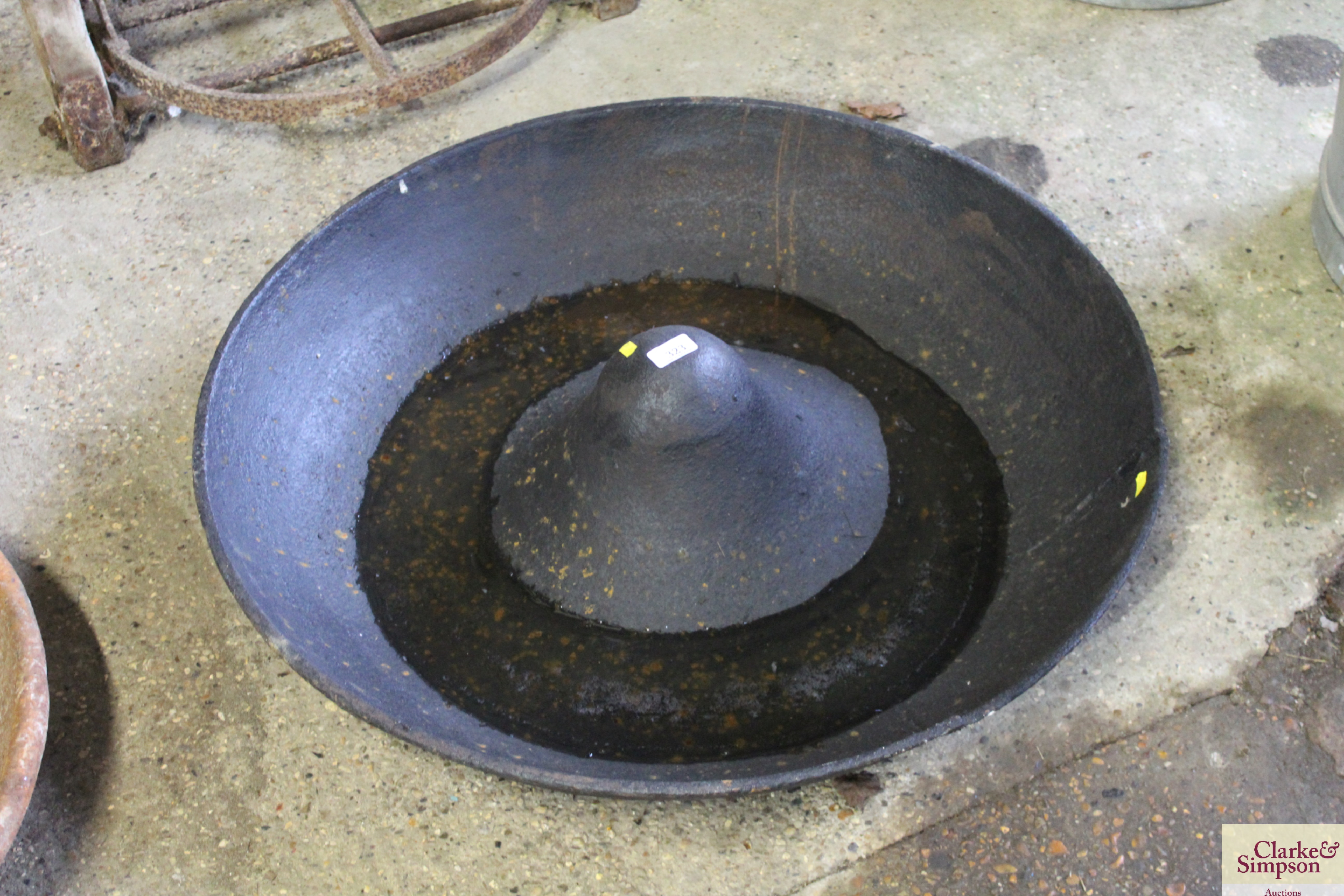 A large circular cast iron pig trough AF