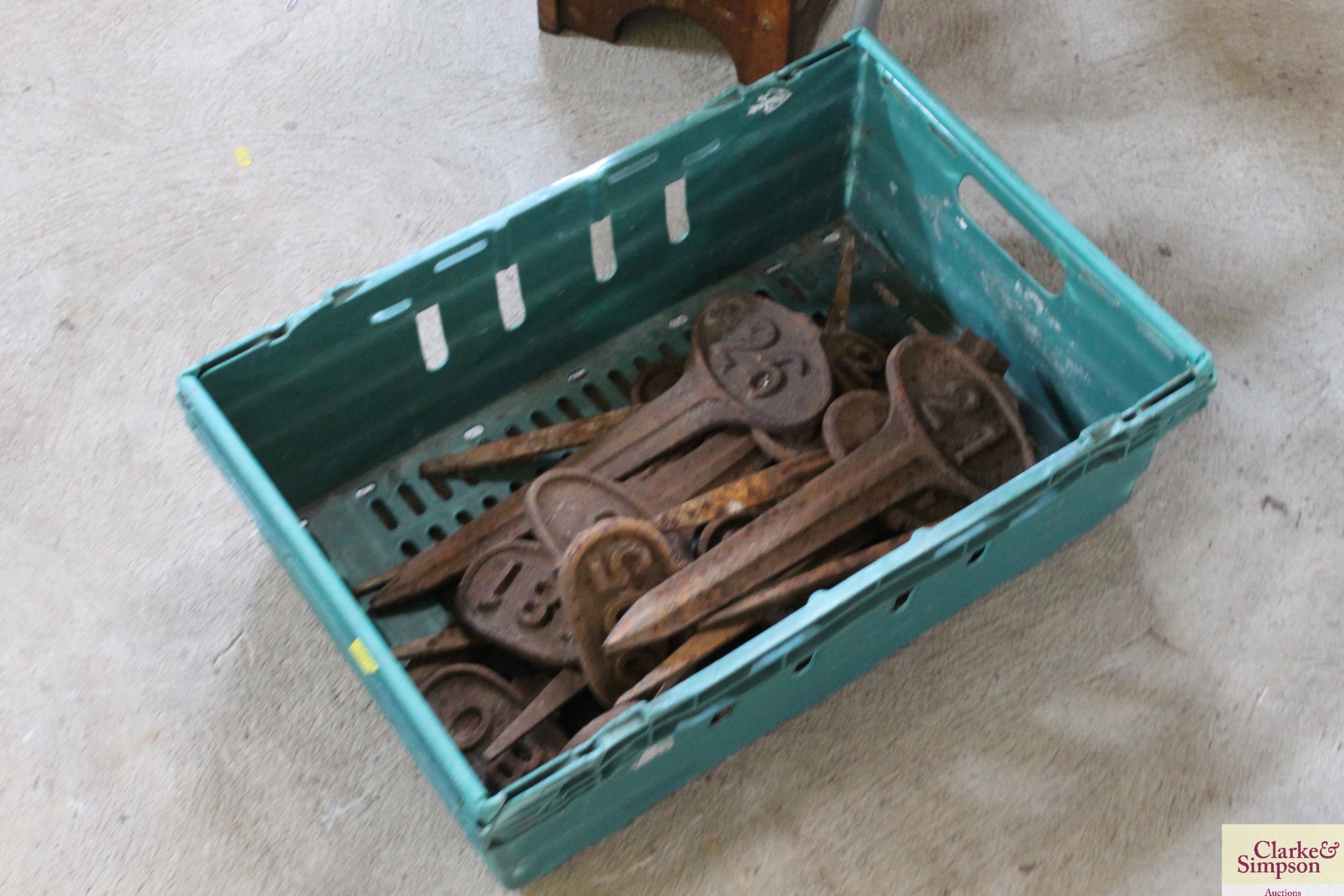 A box containing a quantity of numbered cast iron