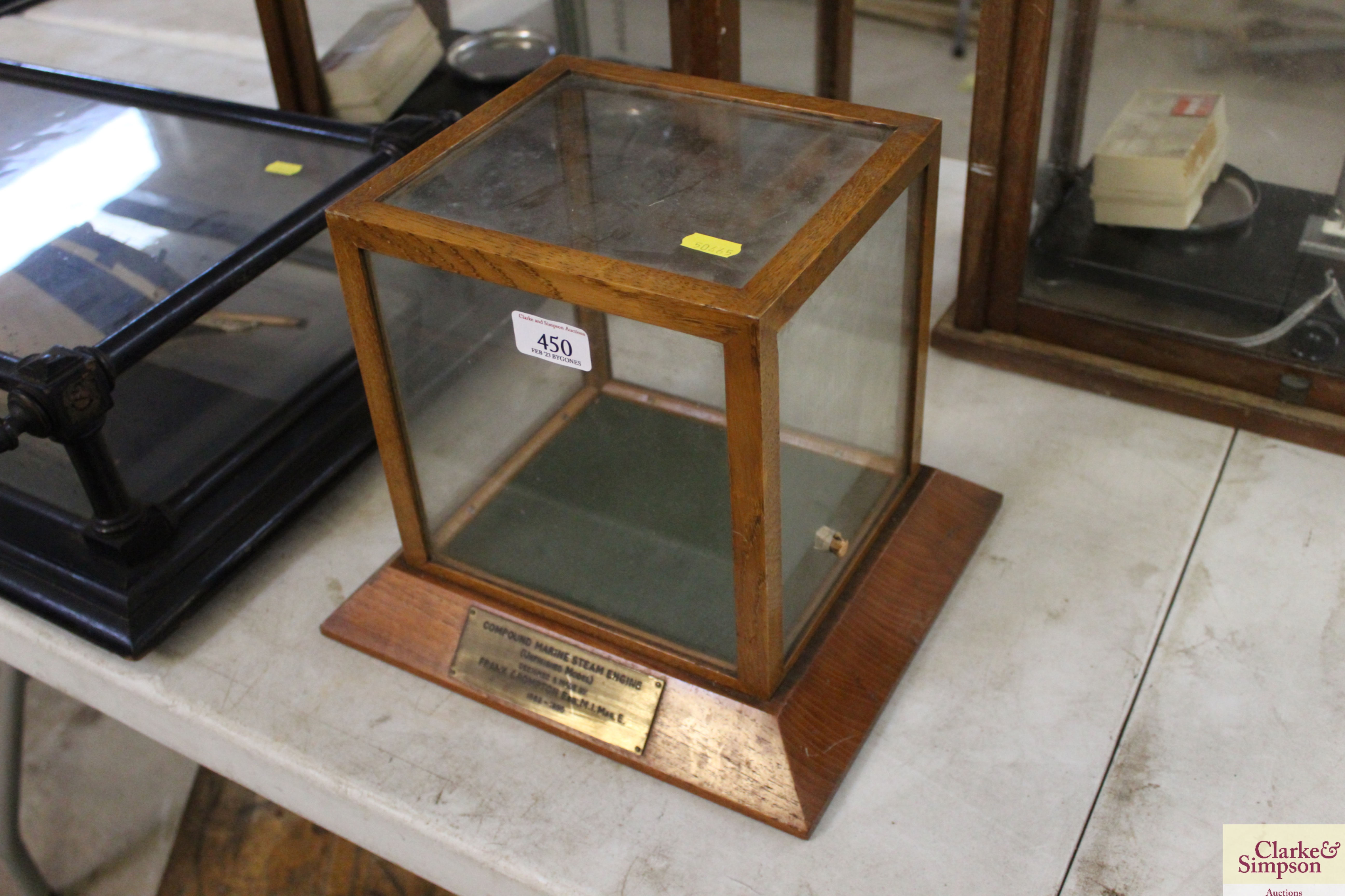 A small oak glazed display cabinet with plaque to