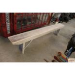 A stripped pine bench, approx. 8ft long