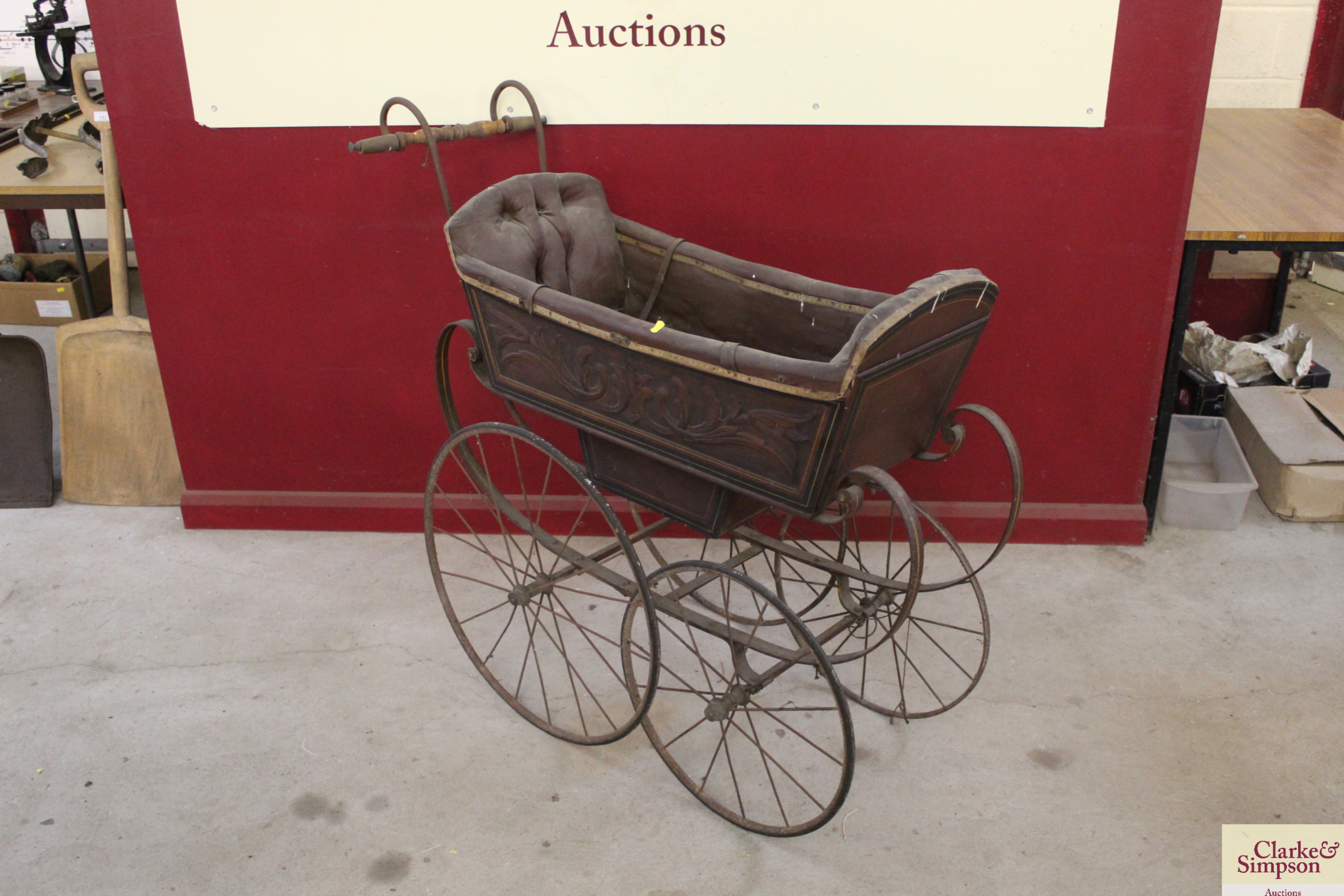 A vintage twin seated and wooden carved pram