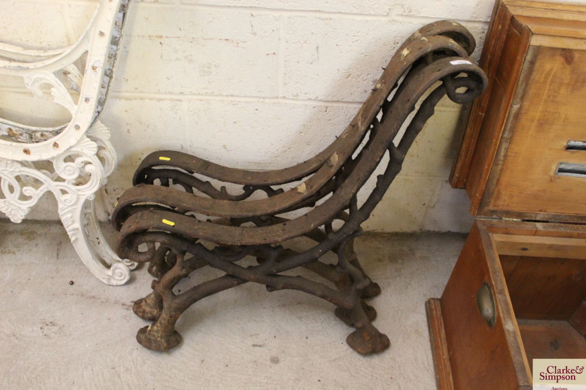 Three ornate cast iron bench supports