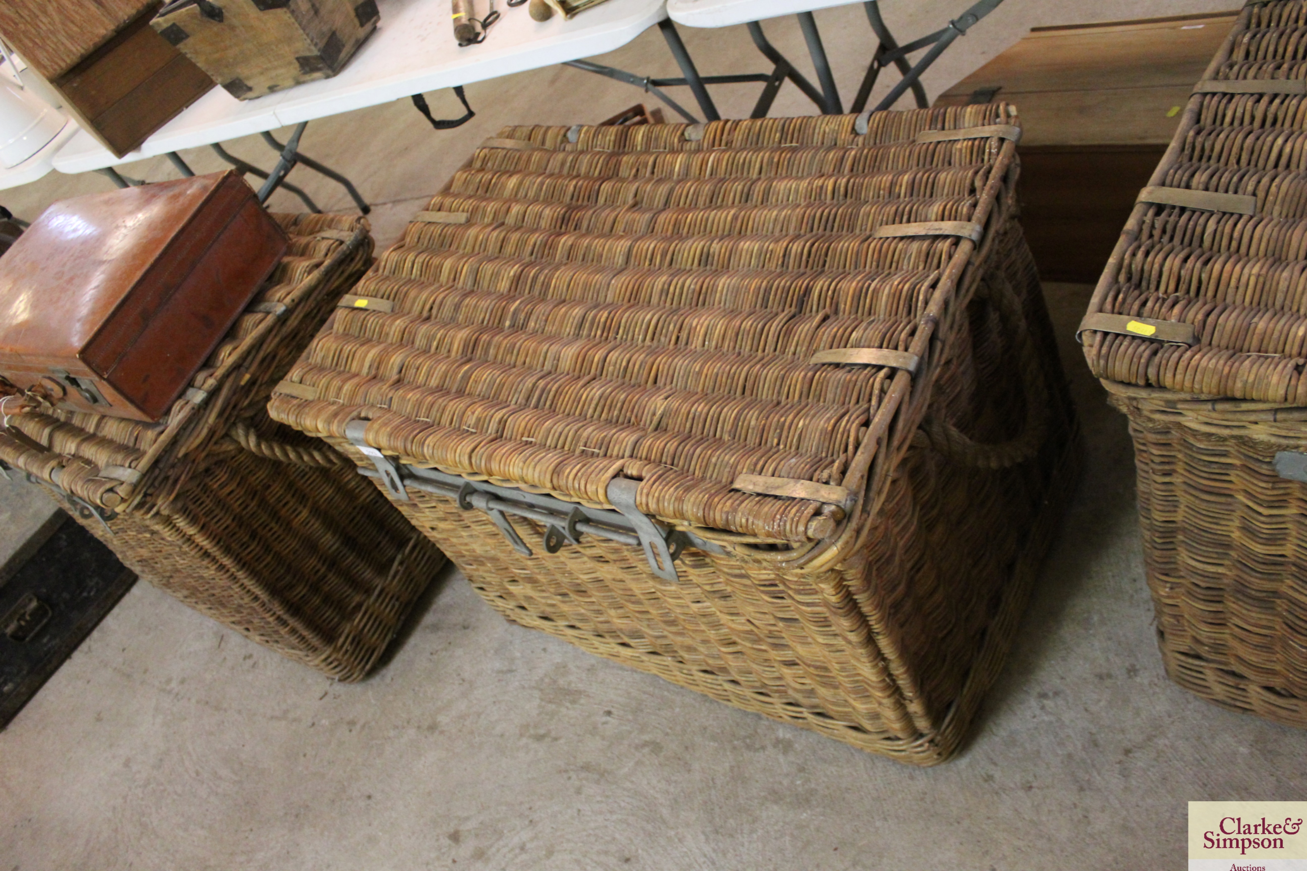 A large wicker and rope handled basket with metal