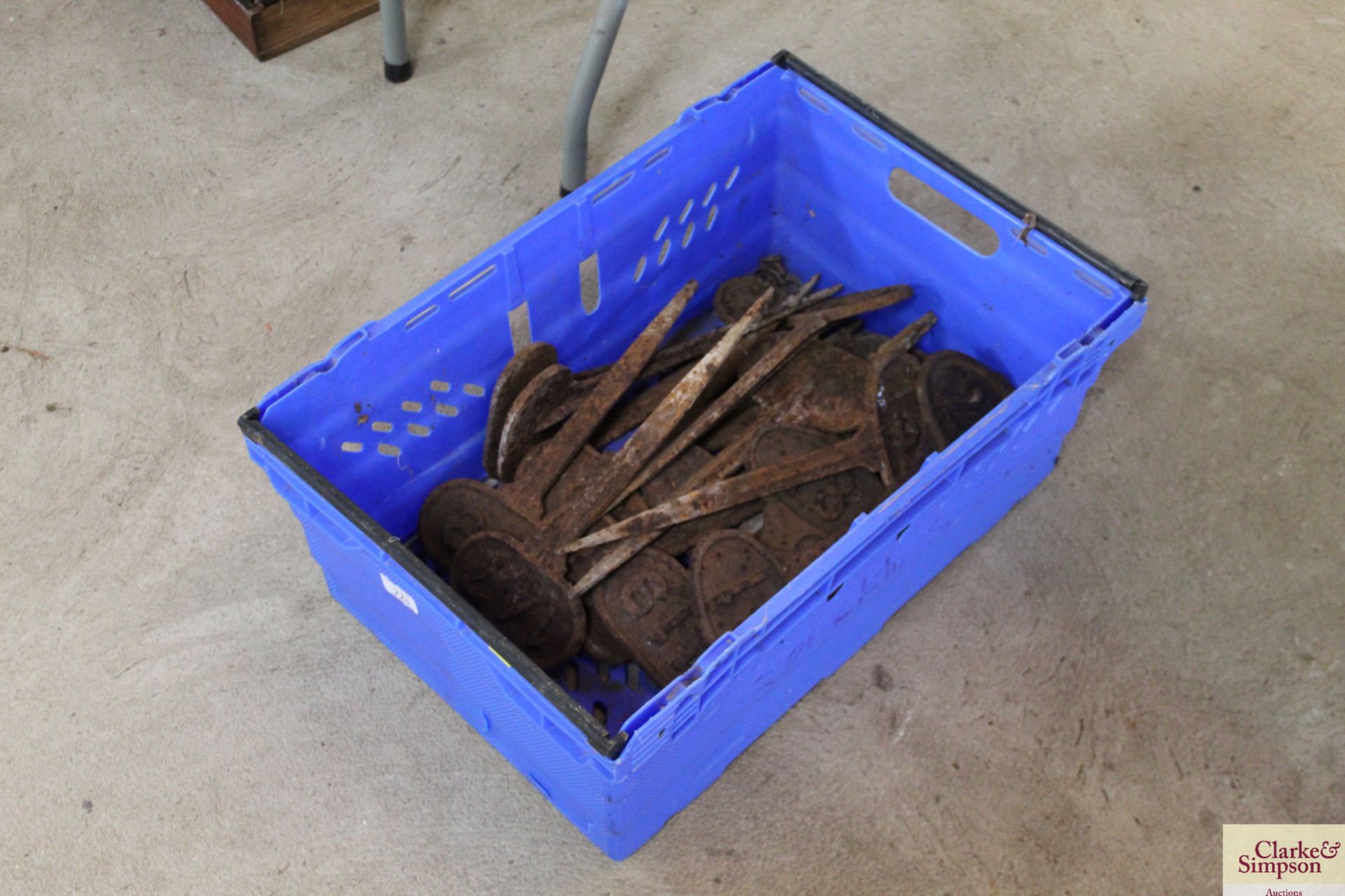 A box containing various numbered cast iron marker