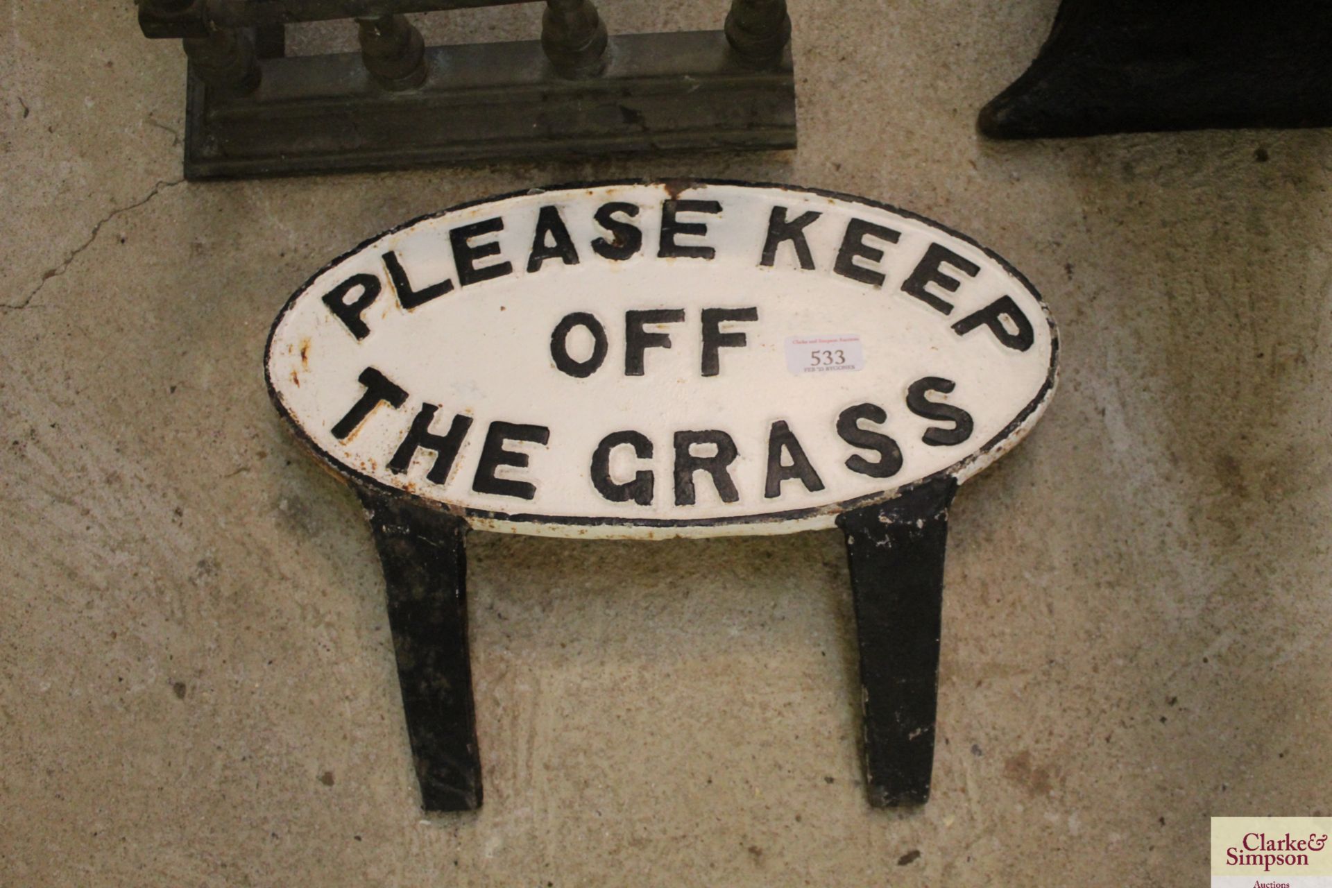 An oval "Please Keep Off The Grass" cast iron sign, approx. 16 1/4" x 8"