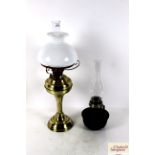 A brass table oil lamp with shade and a Bialladin