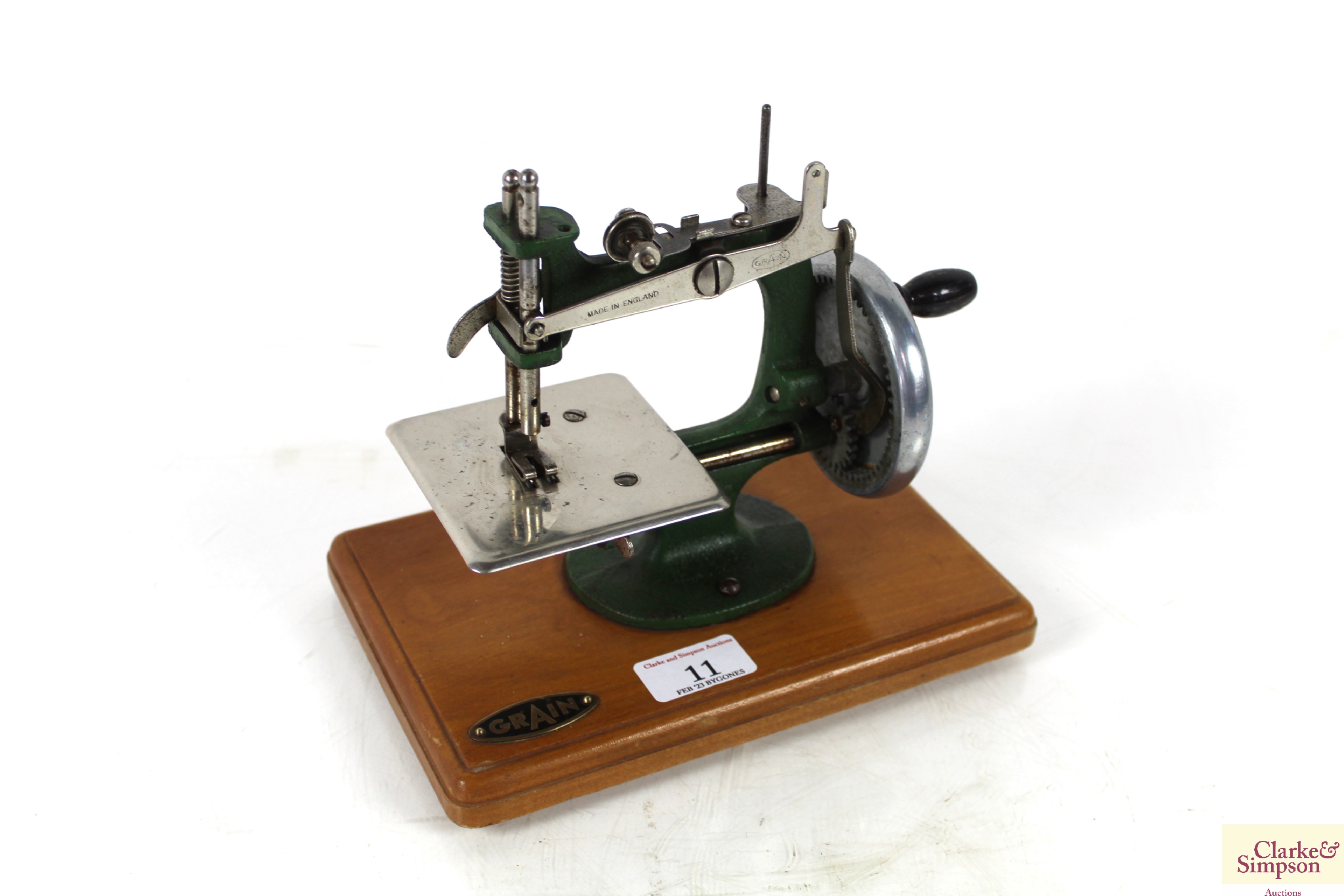 A small child's Grain hand sewing machine on woode