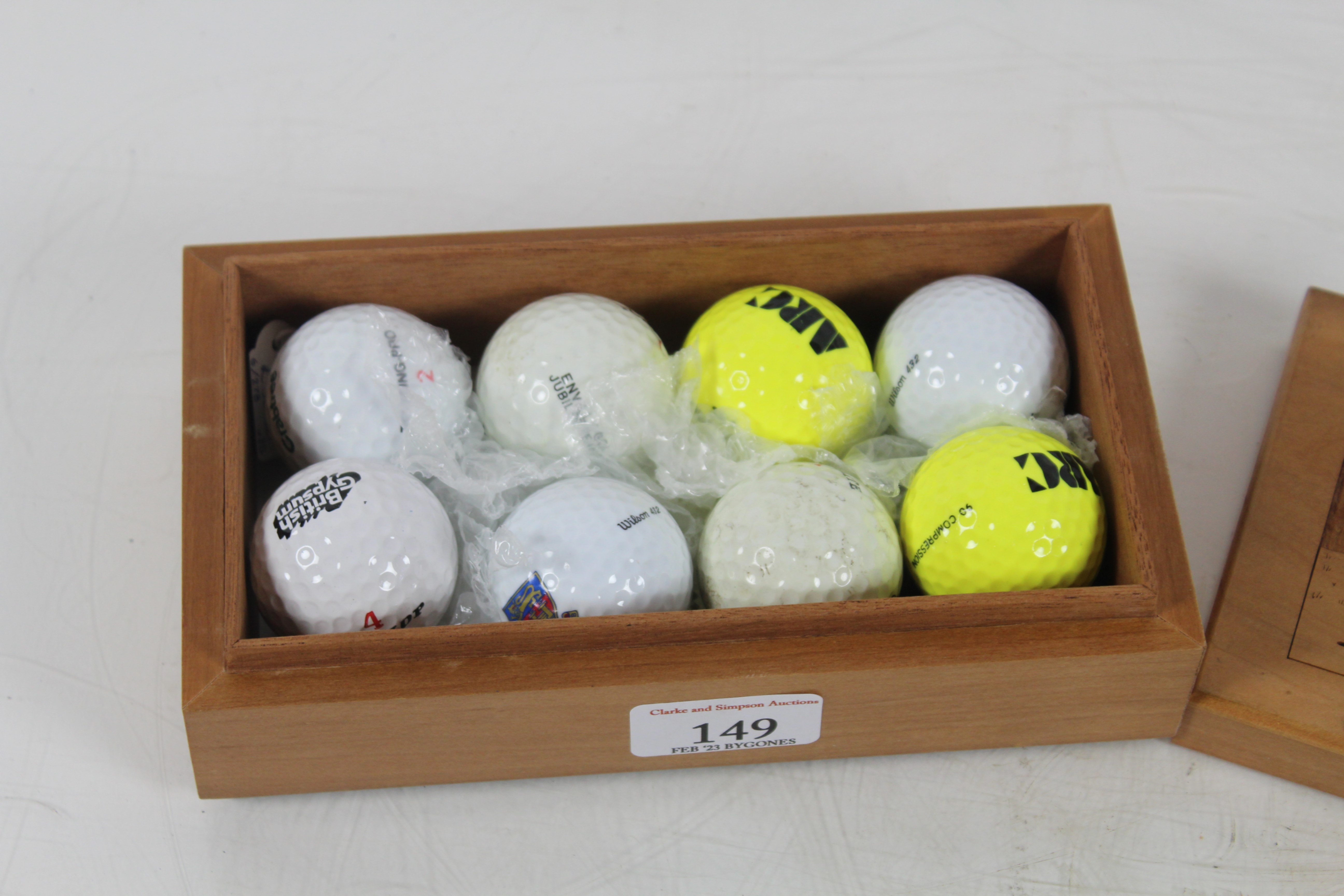 A vintage wooden presentation box containing eight unused golf balls, the lid well carved with - Image 2 of 3