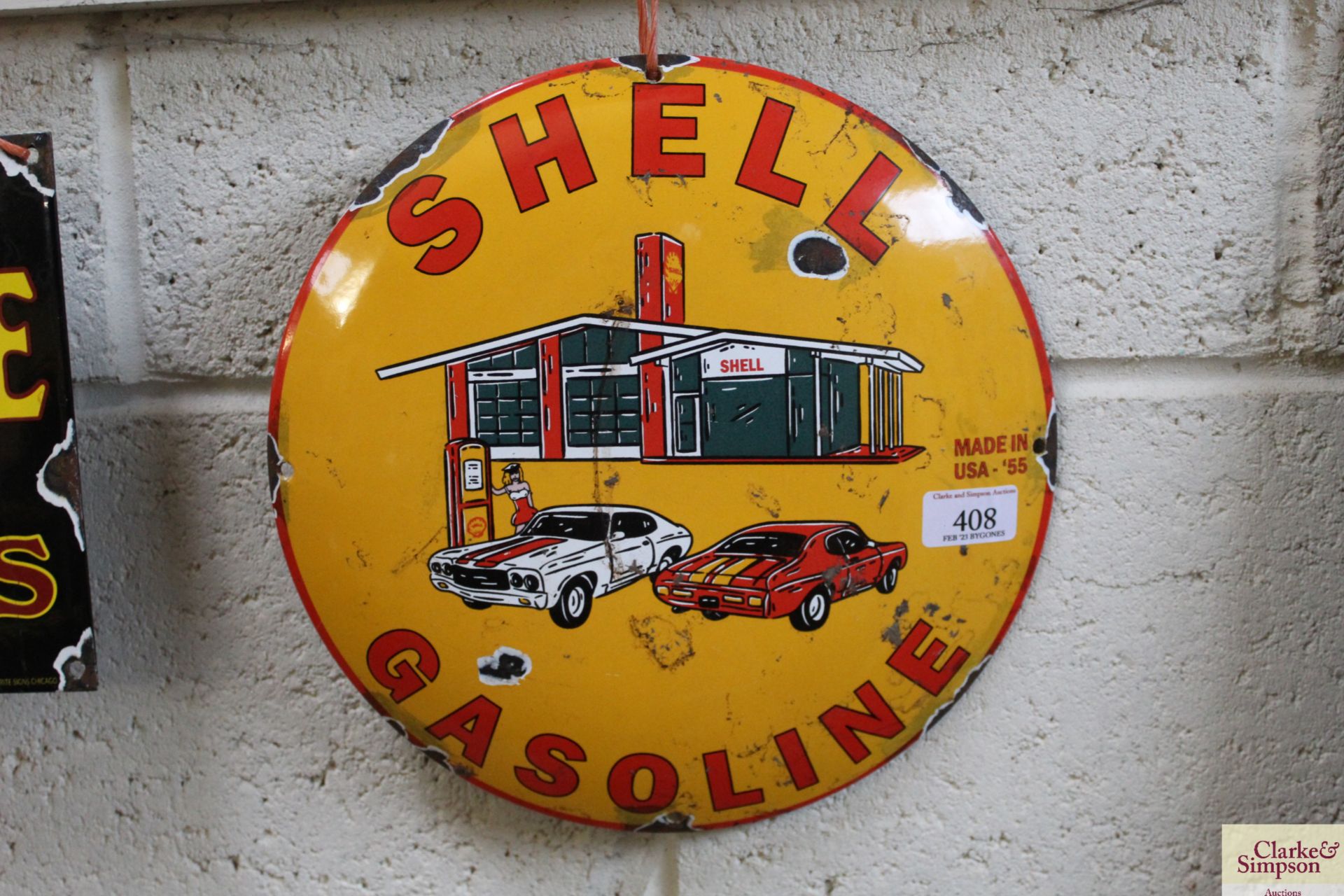 A reproduction "Shell Gasoline" circular enamel ad