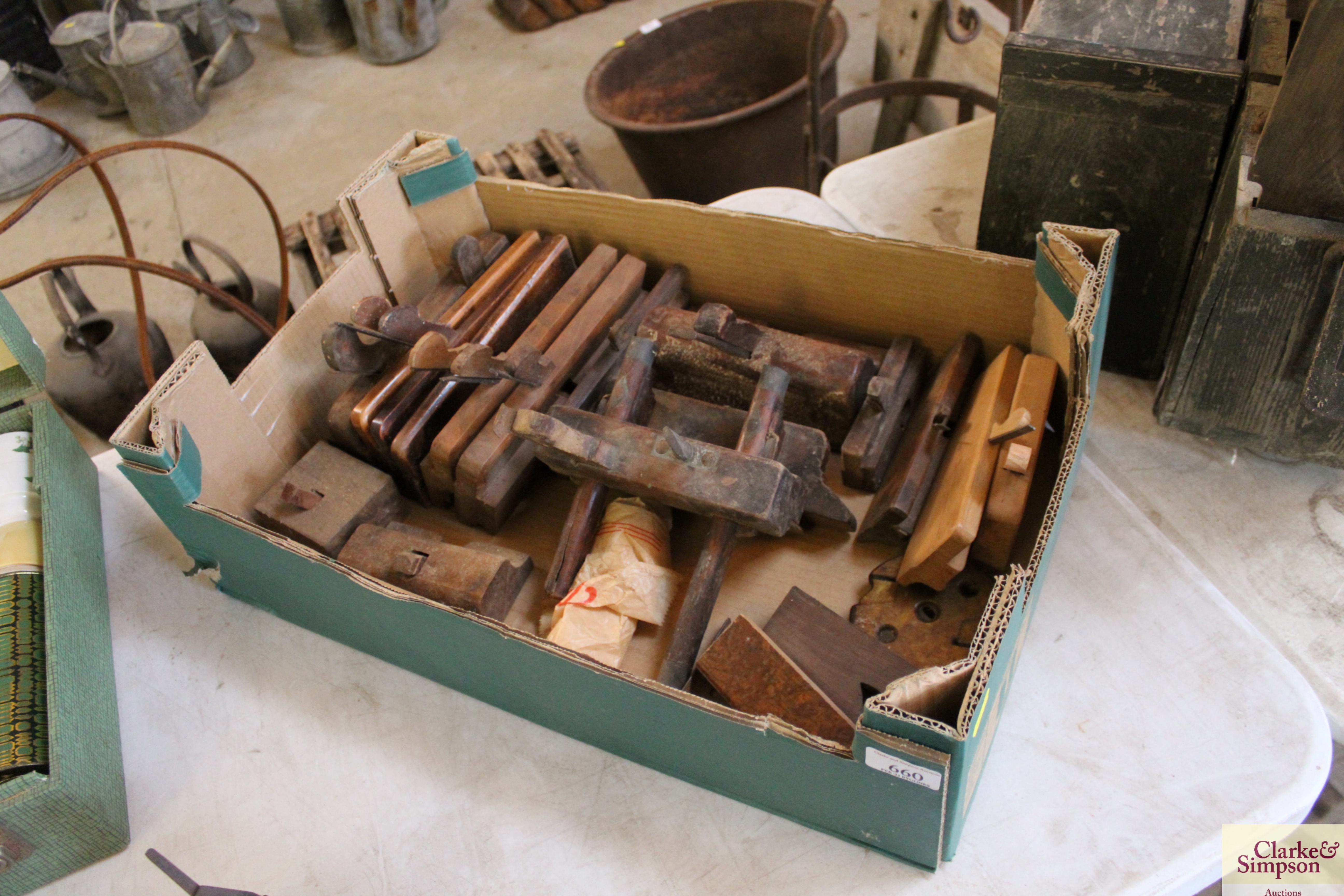 A box of various sized moulding planes etc.