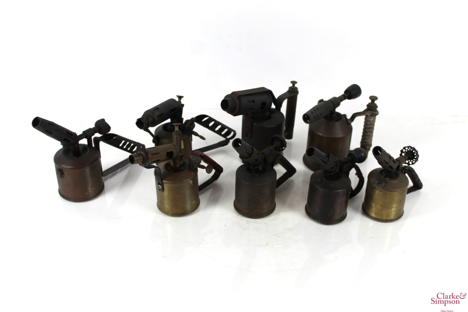 Eight various brass and other blow lamps