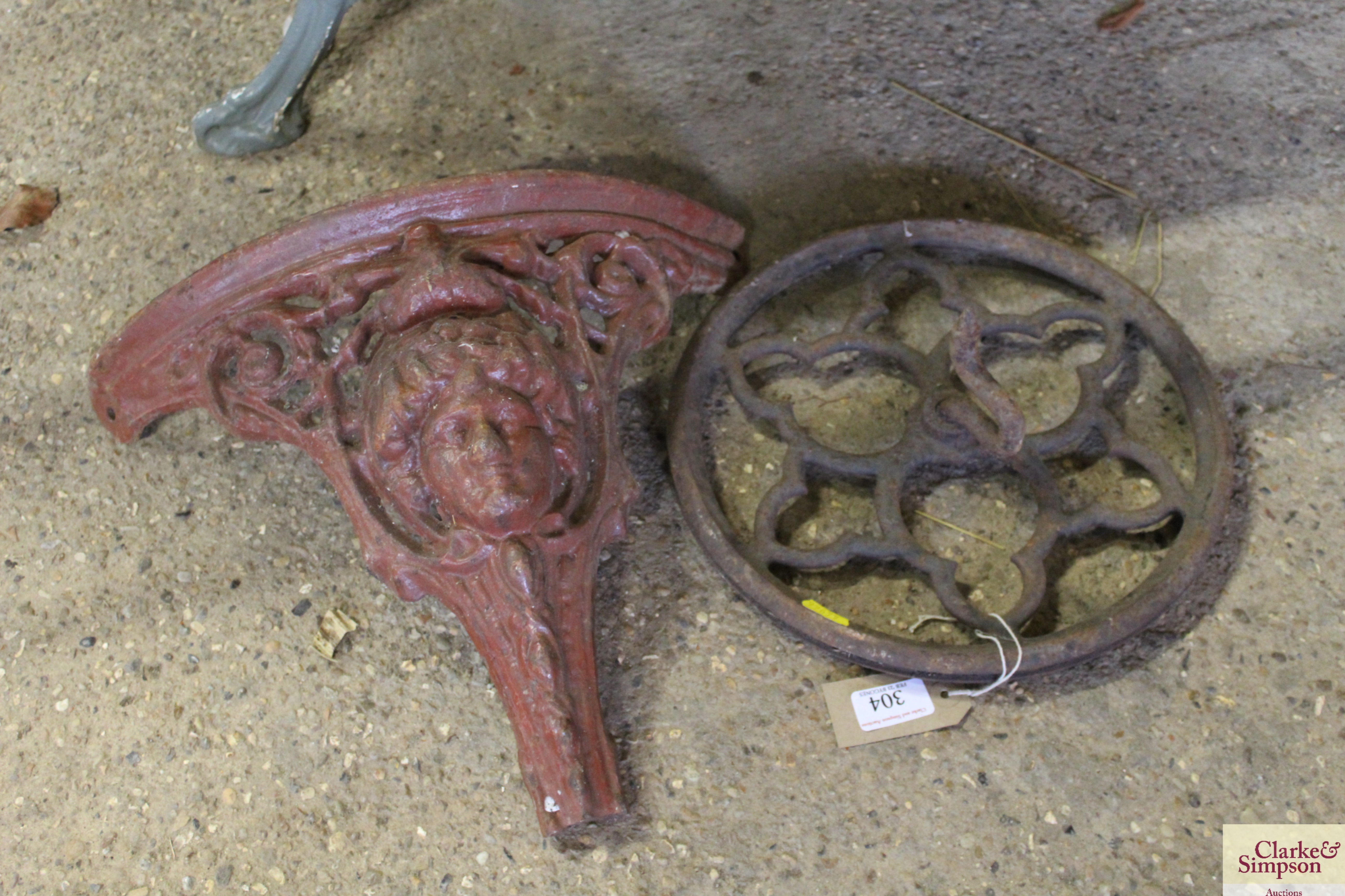 A demi-lune metal cherub decorated bracket etc.