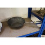 A long handled copper frying pan