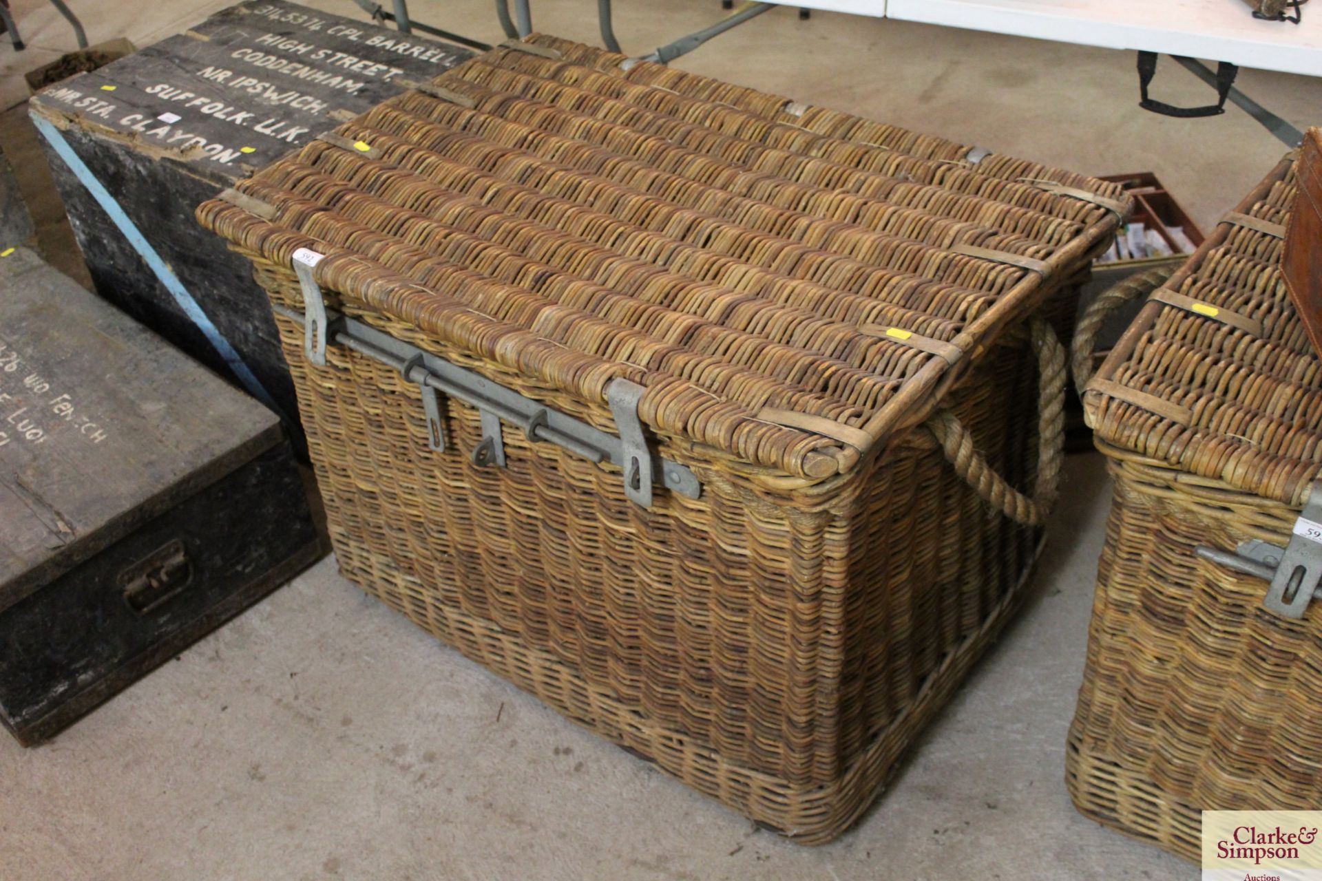 A large wicker and rope handled basket with metal