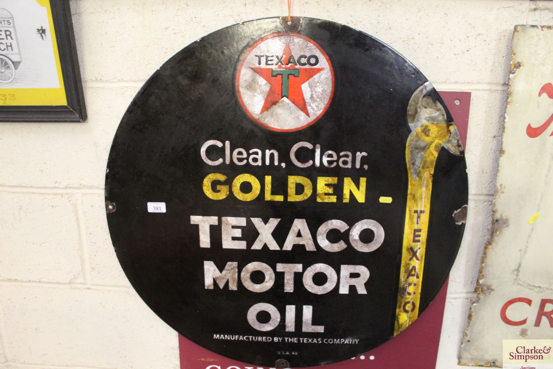 A "Golden Texaco Motor Oil" circular enamel sign,