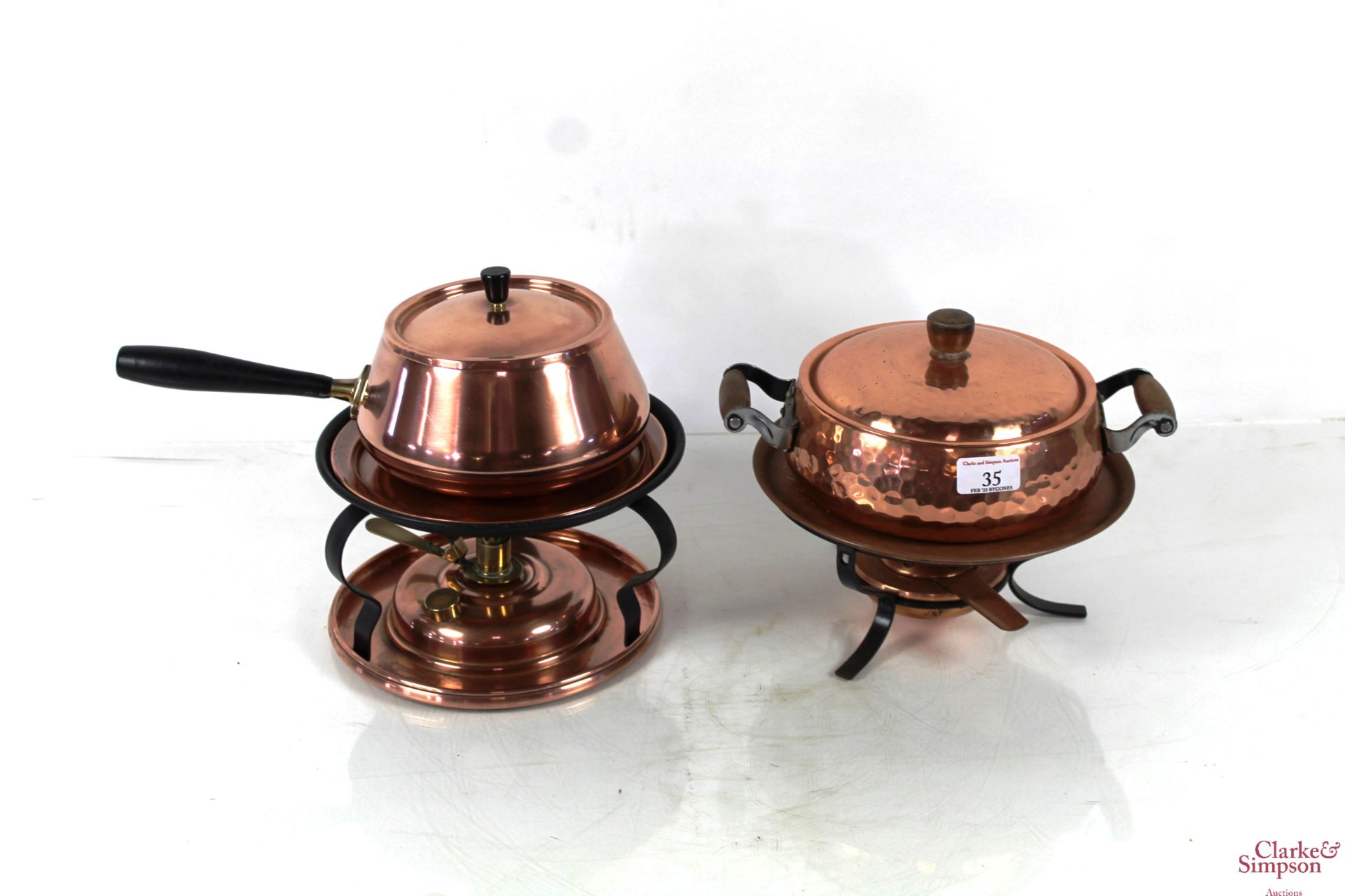 Two copper fondue sets with burners