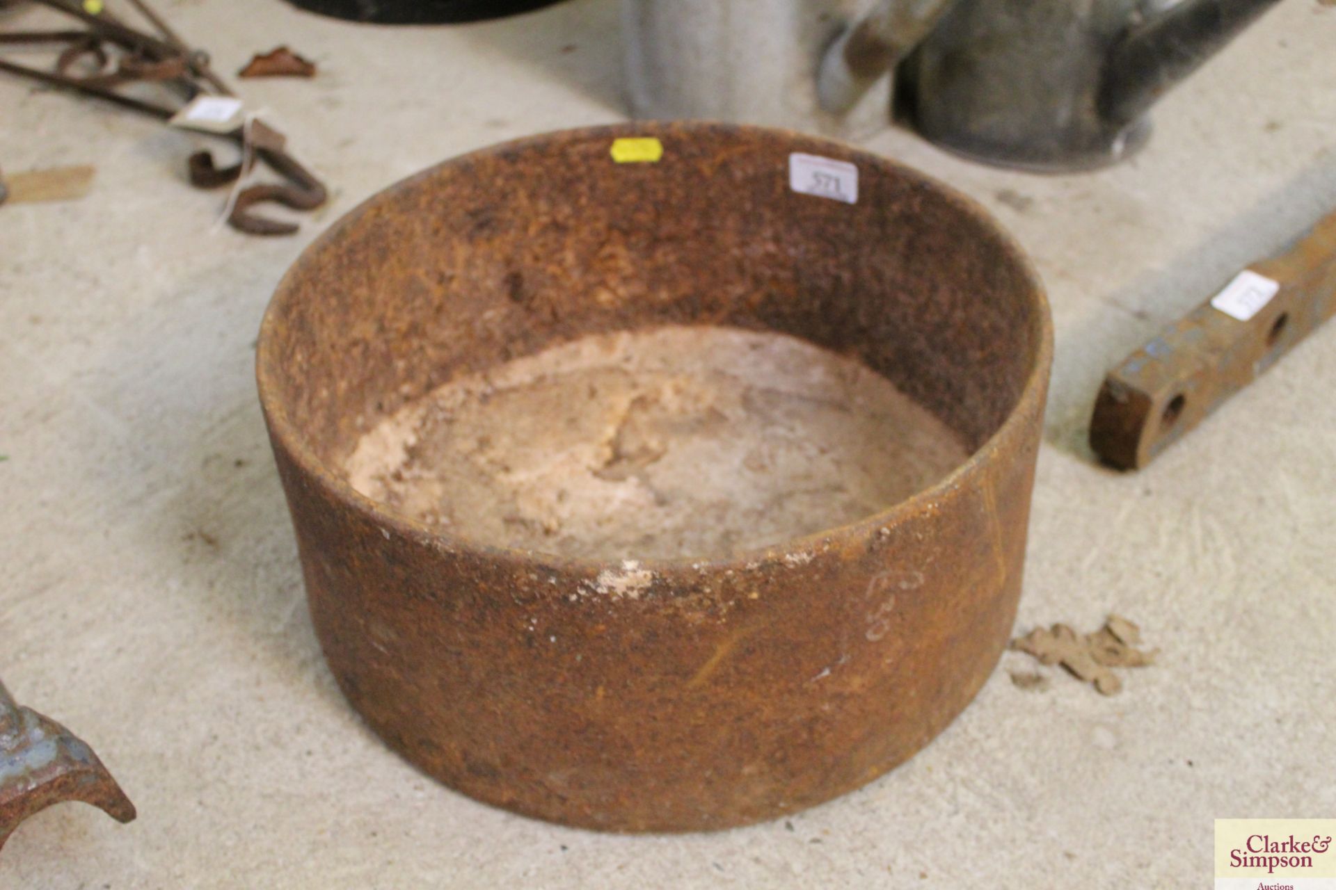 A small circular cast iron feeding trough