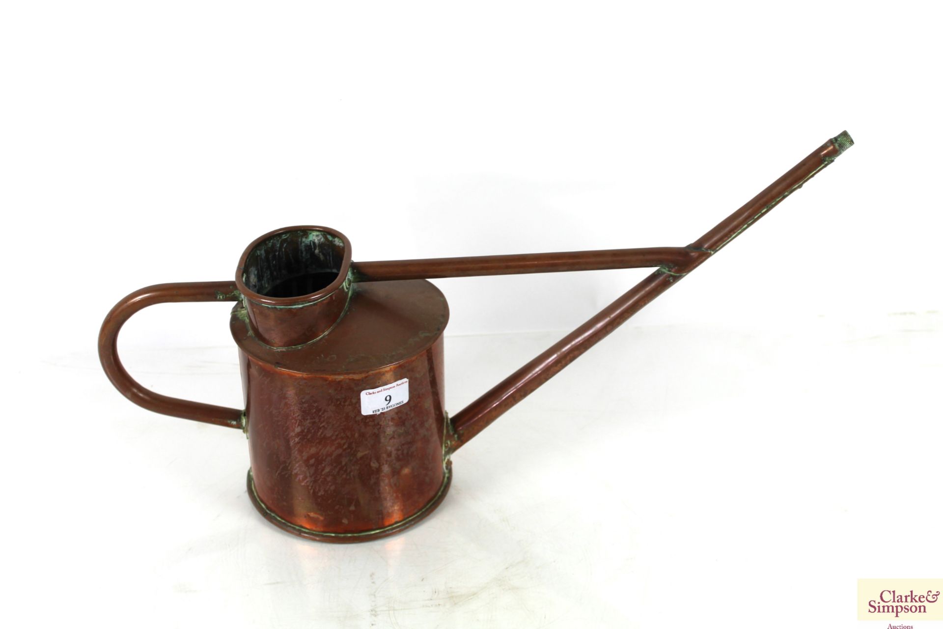 A small copper long spouted watering can