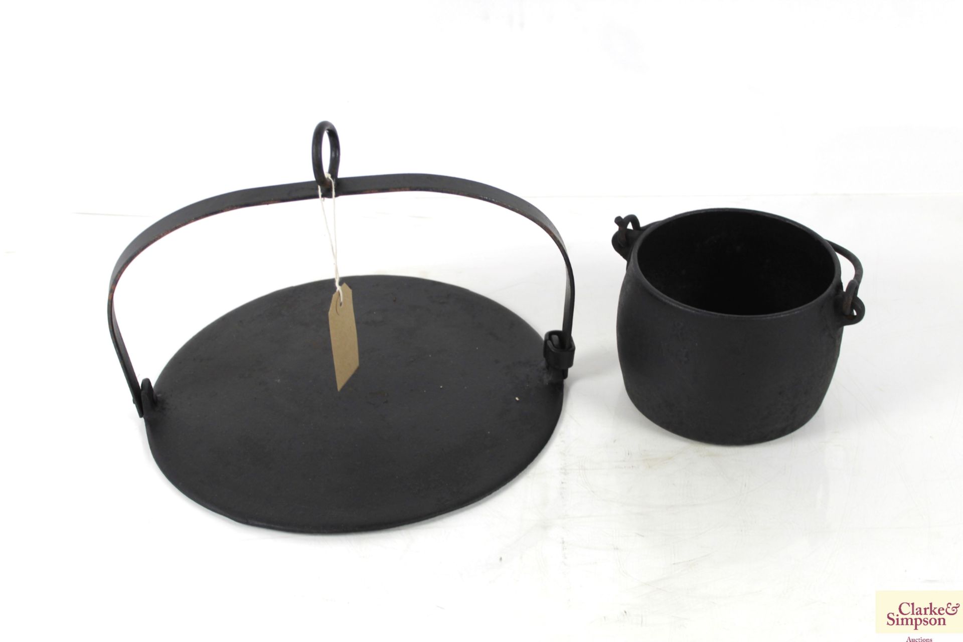 A cooking skillet and a No.4 cast iron cooking pot