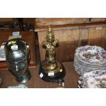 A brass table lamp with figural decoration