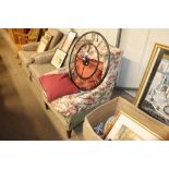 A wing back upholstered armchair with floral cover