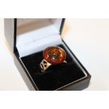 An adjustable 925 and amber coloured ring