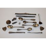 A box containing various silver spoons, silver mou