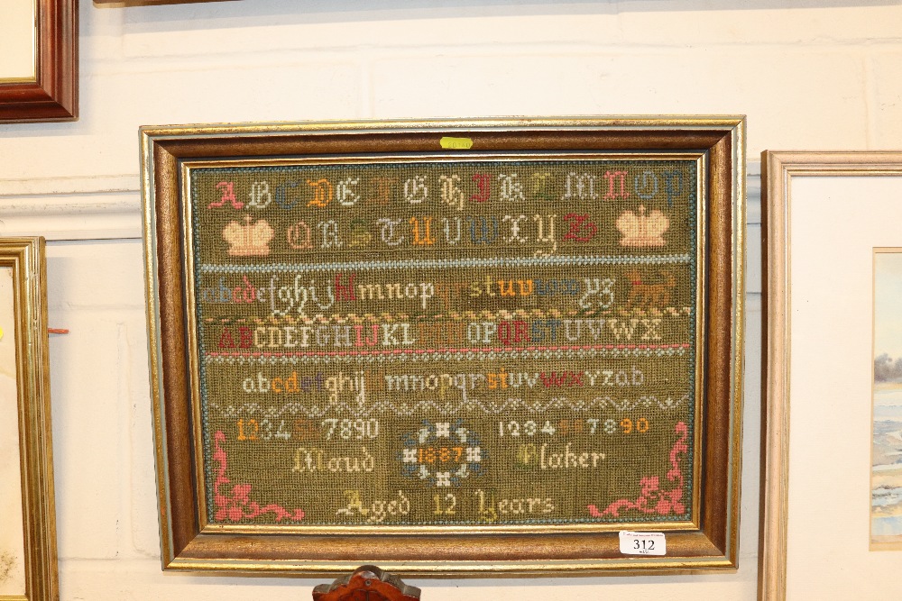 A framed sampler dated 1887