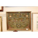 A framed sampler dated 1887