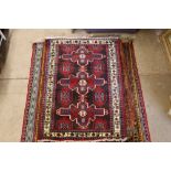 An approx. 3'5" x 4'10" red pattern rug