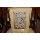 A framed and glazed sampler