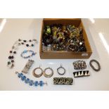 A box of costume jewellery including ear-rings, br