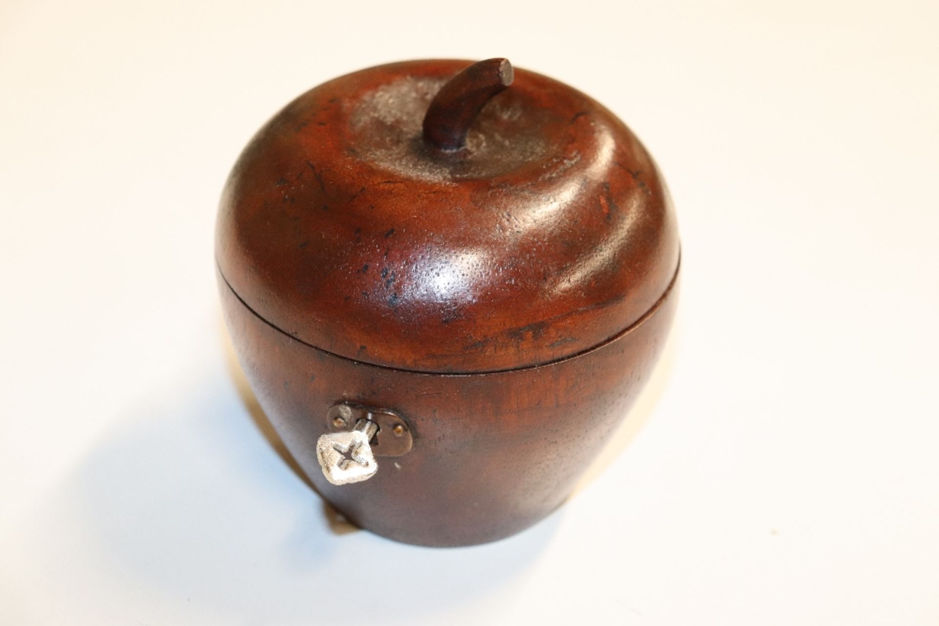 A wooden tea caddy in the form of an apple