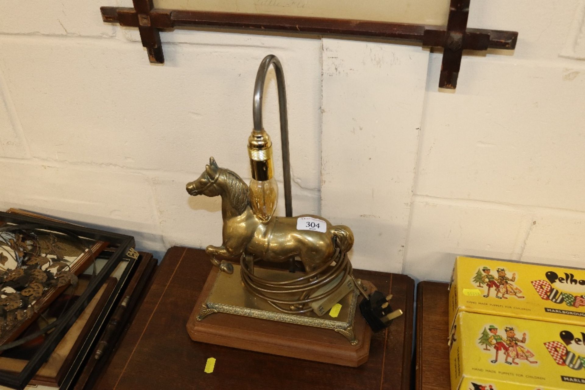 A brass table lamp decorated with horse