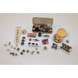 A box containing various buttons, dress studs etc.