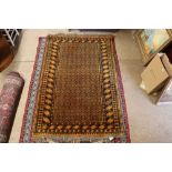 An approx. 4'3" x 6'4" orange patterned rug