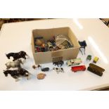 A box containing model cart horses and various far