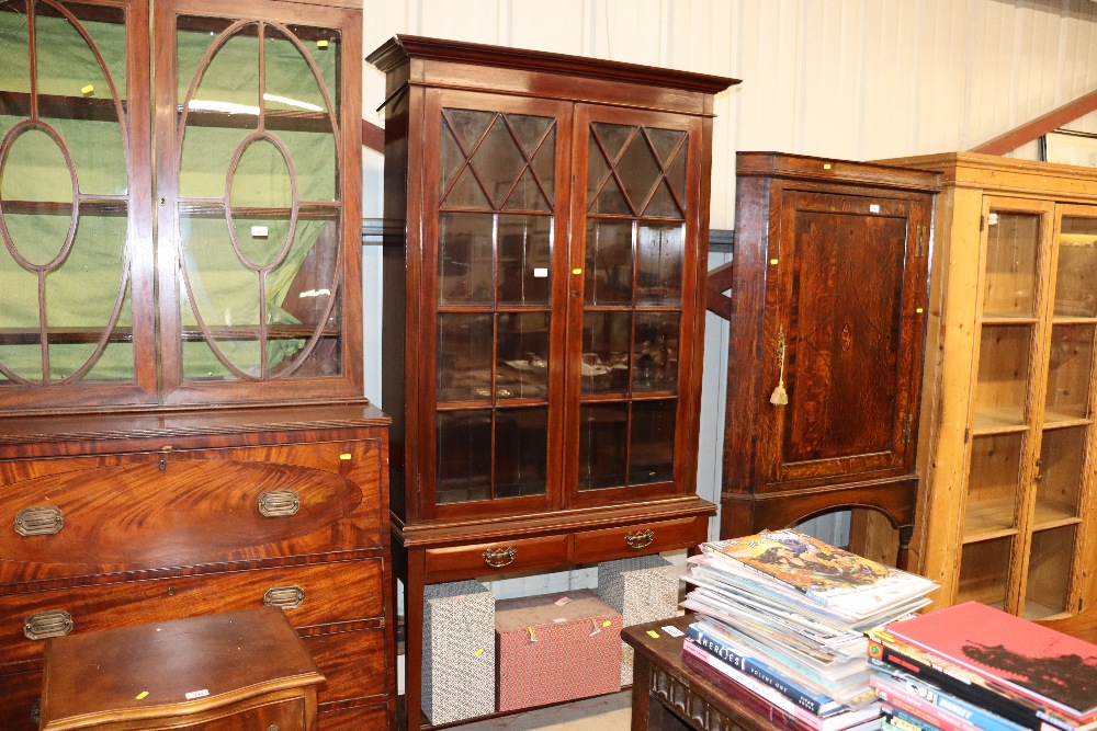 A glazed mahogany bookcase fitted two drawers rais